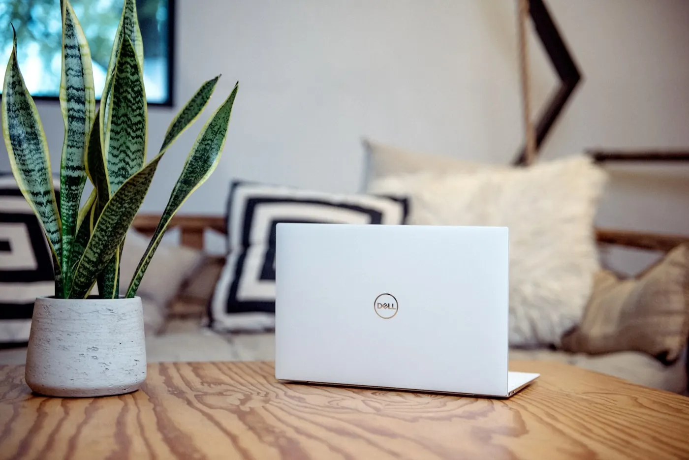 Remote designer's workspace with laptop and design tools